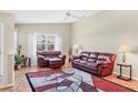 Bright living room with high ceilings, comfortable seating, and a large window overlooking the outdoors at 4107 Brittany Ln # 18, Sarasota, FL 34233