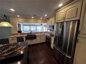 Modern kitchen featuring stainless steel appliances, granite countertops, and ample cabinet space at 4158 Prudence Dr, Sarasota, FL 34235