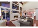 Open living room featuring a stone fireplace, high ceilings, and views of the pool area at 4410 67Th Avenue E Cir, Sarasota, FL 34243