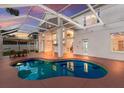 Inviting screened-in pool with connected patio and shaded table for outdoor relaxation at 4410 67Th Avenue E Cir, Sarasota, FL 34243