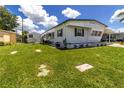 Well-maintained home exterior with green lawn, garden beds and features a shed for extra storage space at 508 50Th Avenue W Plz, Bradenton, FL 34207