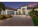 Attractive single Gathering home with tropical landscaping and a paver driveway at 5804 Mulligan Way, Lakewood Ranch, FL 34211