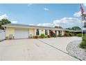 Attractive single-story home with attached garage, vibrant landscaping, and spacious driveway at 6002 34Th W Ave, Bradenton, FL 34209