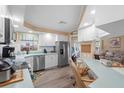 Well-lit kitchen featuring modern stainless steel appliances and updated countertops at 617 Fairmount Dr, North Port, FL 34287