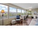 Bright sunroom with water views, perfect for a home office or relaxation at 617 Fairmount Dr, North Port, FL 34287