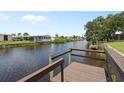 Scenic waterfront view with a wooden dock overlooking the calm water at 617 Fairmount Dr, North Port, FL 34287