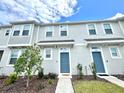 Charming townhome exterior with a well-manicured lawn and eye-catching blue doors at 6253 Whetstone Ct, Palmetto, FL 34221