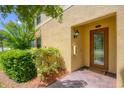 Inviting front entrance with a glass paneled door, lush greenery and brick pavers at 6512 Grand Estuary Trl # 101, Bradenton, FL 34212