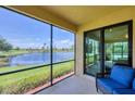 Relaxing screened lanai with a comfortable seating area overlooking a tranquil pond at 6512 Grand Estuary Trl # 101, Bradenton, FL 34212