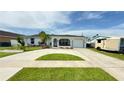 Well-maintained single-story home with a spacious driveway, lush lawn, and vibrant landscaping creating an inviting curb appeal at 8509 La Boca Ave, North Port, FL 34287