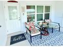 Cozy porch setting features comfortable seating and a clear view, perfect for relaxing and enjoying the surroundings at 8509 La Boca Ave, North Port, FL 34287