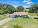 An aerial view of a well-manicured lawn surrounding a cozy home with an attached garage at 9543 Rockhill Rd, Thonotosassa, FL 33592