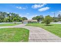Well maintained, single story home with a long driveway and freshly cut lawn at 9543 Rockhill Rd, Thonotosassa, FL 33592