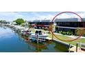 Waterfront property with boat lift, lush landscaping, and a cozy patio area, perfect for enjoying waterfront living at 10311 Waterbird Way, Bradenton, FL 34209