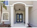 Elegant front entrance showcasing a double door with decorative glass and white pillars at 18307 White Fang Ct, Parrish, FL 34219