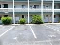 Condo building exterior featuring well-maintained landscaping and clearly marked parking spaces at 1850 Sunny Dr # F4, Bradenton, FL 34207