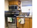 Functional kitchen with stainless steel appliances, granite countertops, and ample storage at 1850 Sunny Dr # F4, Bradenton, FL 34207