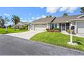 Single-story home with well-manicured lawn, colorful landscaping and a two-car garage at 2417 Fairway Oaks Dr # 22, Palmetto, FL 34221