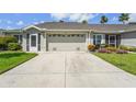 Single-story home featuring a two-car garage, neutral-colored exterior, and well-maintained landscaping at 2417 Fairway Oaks Dr # 22, Palmetto, FL 34221