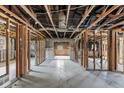 Interior shot of a gutted home with exposed wooden framing and concrete floors, ready for renovation at 268 Alsace Ave, Venice, FL 34293