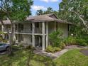 Two-story condo building featuring balconies and landscaping, set in a lush green environment at 3003 Quail Holw # 10, Sarasota, FL 34235