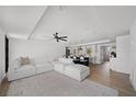 Bright, open-concept living room featuring modern decor, neutral color palette and wood flooring at 326 Randolph Rd, Venice, FL 34293
