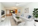 Bright living room with tile floors, modern furnishings, and an open floor plan at 3985 Maceachen Blvd # 224, Sarasota, FL 34233