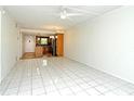 Spacious living area with tile flooring, ceiling fan, and access to the kitchen at 3985 Maceachen Blvd # 224, Sarasota, FL 34233