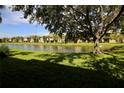 Scenic view of a well-maintained backyard and tranquil lake, providing a serene and picturesque setting at 4026 Overture Cir # 487, Bradenton, FL 34209