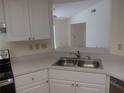 Bright kitchen with white cabinets, updated countertop, and stainless steel appliances at 4154 Center Pointe Cir # 57A, Sarasota, FL 34233