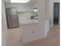 Bright kitchen features stainless steel refrigerator, white cabinets and light countertops at 4154 Center Pointe Cir # 57A, Sarasota, FL 34233