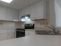 This eat-in kitchen features stainless steel appliances, white cabinets and light countertops at 4154 Center Pointe Cir # 57A, Sarasota, FL 34233