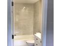 Bright bathroom featuring tub with white tile, and modern vanity at 5178 Lake Village Drive # 86, Sarasota, FL 34235