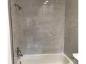 White tiled shower, featuring modern showerhead and faucet fixtures at 5178 Lake Village Drive # 86, Sarasota, FL 34235