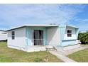 Well-kept single-story home, featuring a cozy porch area and a neatly landscaped yard at 5233 Kenwood Ave, Sarasota, FL 34234