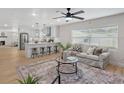 Open-concept living room and kitchen with modern finishes and plenty of natural light at 5718 Magnolia N St, St Petersburg, FL 33703