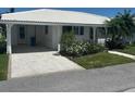 Inviting home with covered parking, white tile roof, and well-maintained landscaping at 675 El Centro # 675, Longboat Key, FL 34228