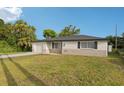 Well-kept single-story home with a lush green lawn and a traditional architectural style at 6961 Alken Cir, New Port Richey, FL 34653