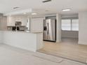 Bright, open kitchen featuring stainless steel appliances, a breakfast bar, and a modern design at 6961 Alken Cir, New Port Richey, FL 34653