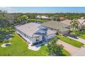 Scenic aerial view of a home overlooking a tranquil pond and lush greenery at 7005 Goldrush Ln, Bradenton, FL 34201