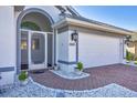 Close up view of the front entrance showing the white garage door and tiled pathway at 7005 Goldrush Ln, Bradenton, FL 34201