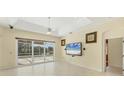 Bright living room with sliding glass doors, tile flooring and a ceiling fan at 7005 Goldrush Ln, Bradenton, FL 34201