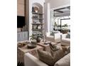 Cozy living room features custom shelving, decor, and comfortable seating, creating a welcoming atmosphere at 1166 Blue Shell Loop, Sarasota, FL 34240