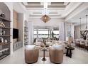 Bright open-concept living room offers water views, neutral tones, and modern decor, creating a luxurious space at 1166 Blue Shell Loop, Sarasota, FL 34240