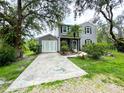 Charming two-story home featuring black shutters, well-maintained landscaping, and an attached garage at 25640 State Road 70 E, Myakka City, FL 34251