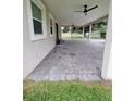 Angle shot of the home's exterior featuring brick pavers, manicured lawn and partially covered patio at 328 20Th W St, Palmetto, FL 34221