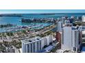 An aerial view of the marina with city buildings, sailboats, yachts, and gorgeous blue ocean waters at 33 S Palm Ave # 1501, Sarasota, FL 34236