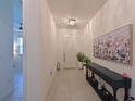 Inviting entryway with tile flooring, elegant console table, and decorative wall art at 3419 74Th Avenue E Cir, Sarasota, FL 34243