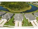 Aerial view of home highlighting expansive lot, paired driveways, and proximity to a serene pond at 4609 Deep Creek Ter, Parrish, FL 34219