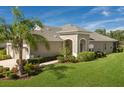 Charming single-Gathering home with manicured lawn, complemented by beautiful shrubbery and a palm tree at 4609 Deep Creek Ter, Parrish, FL 34219